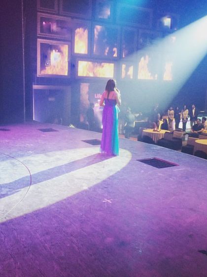 This photo captures the feeling of being alone in the spotlight, a moment that can feel either intimidating or exhilarating. My mission is to help you feel humble in that spotlight and connected to your audience, turning that pressure into a source of energy and confidence.