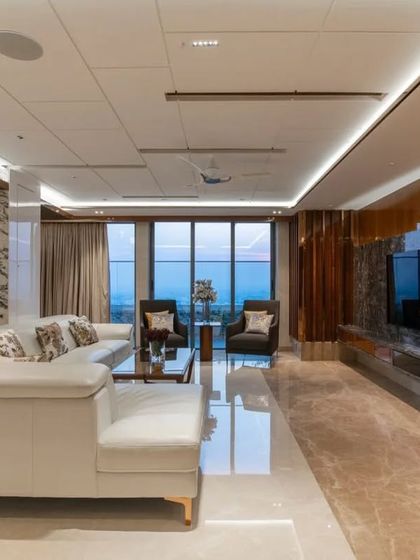 A view of the living area with the city skyline visible through the large windows, demonstrating how we frame views to be a part of the interior design.
