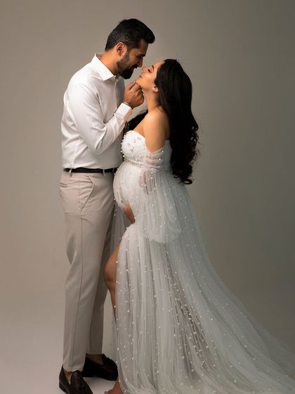 An intimate portrait capturing the deep connection between partners. This is a perfect example of a classic couple's maternity photo.