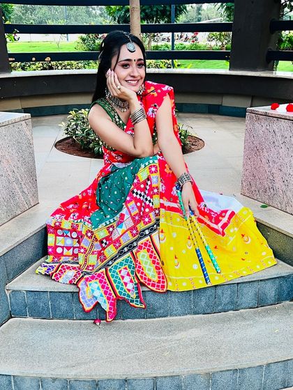 A playful pose in a traditional Garba outfit. The makeup is bright and festive, perfect for the nine nights of celebration.