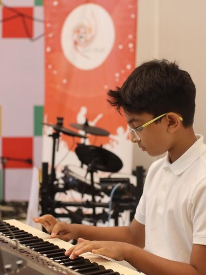A focused keyboardist playing at our Swirl Spotlight event at MuSo. We prepare students for graded exams and live performances with equal dedication.