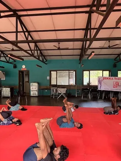 This pose, known as the Happy Baby Pose (Ananda Balasana), is excellent for releasing tension in the lower back and hips after a strenuous workout. It is an integral part of our cool-down and recovery sessions.