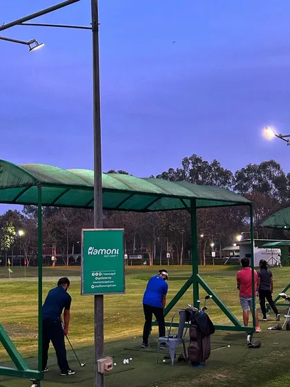 The floodlights illuminate the range, creating a perfect atmosphere for night golf.