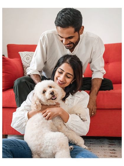 A warm and loving portrait of Dinkan and his family on their bright red sofa. The genuine smiles and relaxed poses make this a perfect lifestyle shot.