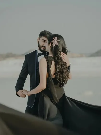 A romantic dance pose, with the bride's flowing black gown adding a touch of elegance and movement. This is a timeless and sophisticated pre-wedding shot.