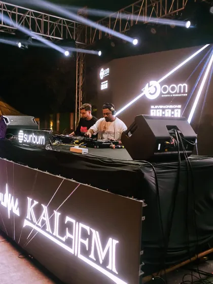 A side view of the impressive DJ setup at a Sunburn event. Professional gear and stage presence are key for large-scale productions.