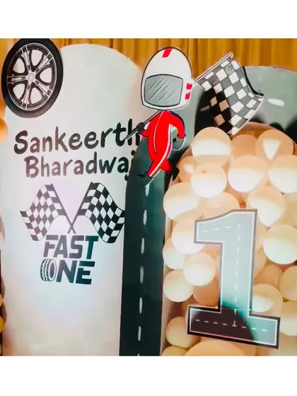Another angle of the "Fast One" birthday theme, showing the custom arch with the number '1' and racer graphic. The details make this setup a perfect photo opportunity for the birthday boy and his guests.