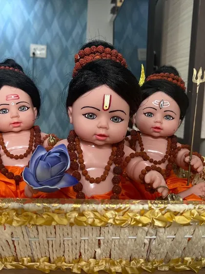 A wider view of the handcrafted Guru Dev Datta dolls, nestled in a decorative basket. We take pride in creating these unique, custom devotional pieces.