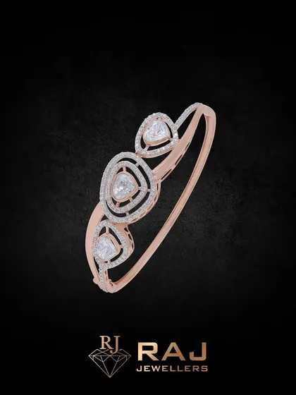 A beautiful rose gold bracelet with three triangular stones set in a modern, openwork frame. The geometric design is both elegant and eye-catching.