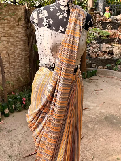 The pre-draped style of this saree makes it easy to wear while still looking incredibly stylish. It's paired with a contemporary bralette-style blouse.