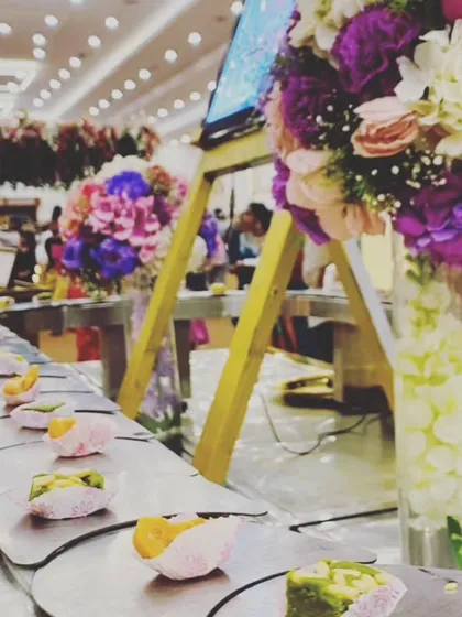 Another look at our popular dessert conveyor belt, decorated with fresh flowers. This unique presentation style is a conversation starter and a delight for guests of all ages.