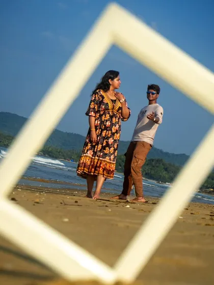 A fun and cool pose from the framed photoshoot series. The groom points at the camera while the bride looks on, adding a playful vibe to their pre-wedding pictures.