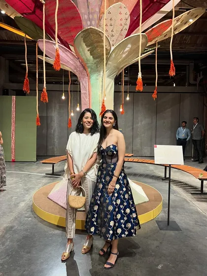 Posing with a friend at the Warp n Weft exhibition. Events like these are a great way to connect with designers and see the latest collections up close.
