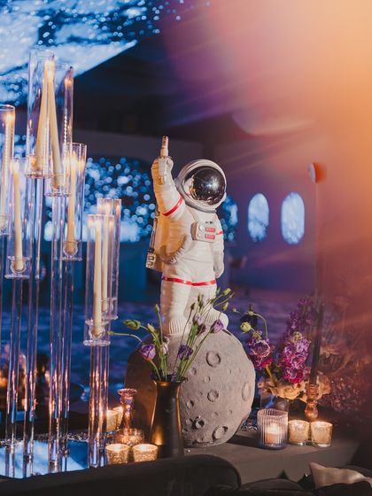 For our 'Interstellar' theme, no detail was too small. A life-sized astronaut figure stands among floral arrangements, adding a touch of playful surrealism to the sangeet decor.