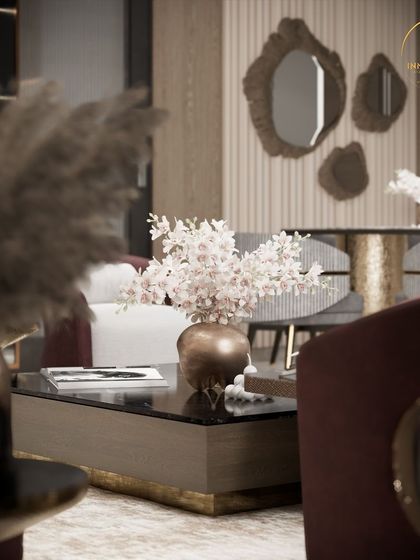 A detailed view of a living room, focusing on the coffee table styling and the unique, organic-shaped mirrors in the background. This image highlights my attention to detail in selecting decor that complements the overall design.