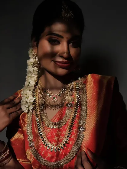 An artistic shot with shadows falling on the bride's face, creating a dramatic and beautiful effect that highlights her features and the makeup.