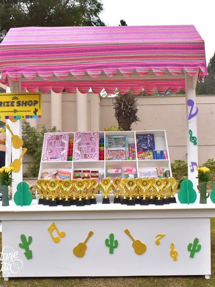The 'Prize Shop' at the Fiesta party, decorated with musical notes and cactus cutouts, where kids could redeem tickets for fun prizes.