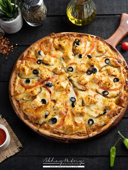 For this pizza, I created a dark, moody atmosphere to make the vibrant toppings and melted cheese the undeniable hero. The overhead angle, known as a flat lay, allows customers to see all the fresh ingredients at once, making it a perfect shot for menus and social media promotions.