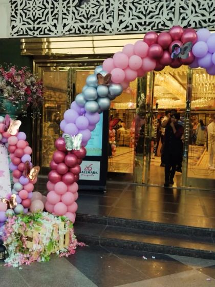 Another view of the entrance arch, showing the mix of chrome and pastel balloons with butterfly accents.