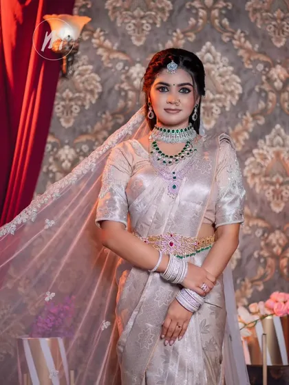 This look is pure elegance. I paired a silver Kanjeevaram saree with stunning diamond and emerald jewellery. The makeup is kept sophisticated and clean to highlight the beauty of the outfit.