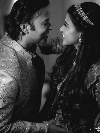 A classic black and white shot capturing the happy conversation and connection between the bride and groom.