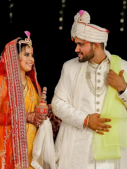 A happy, interactive moment between the bride and groom during their wedding rituals. Their smiles and eye contact show the deep connection and friendship they share.