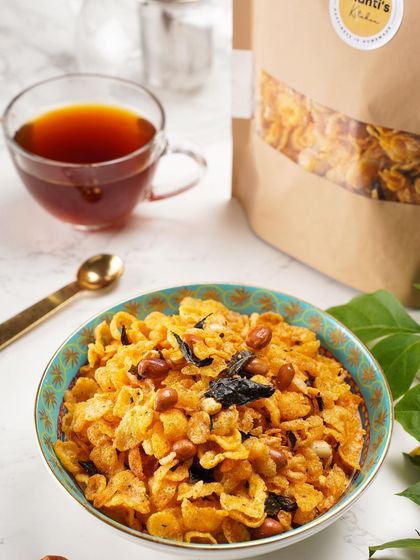 My homemade Corn Mixture is a new coffee-time best friend. It's a crunchy blend of cornflakes, peanuts, and curry leaves, all tossed in my special spice mix.