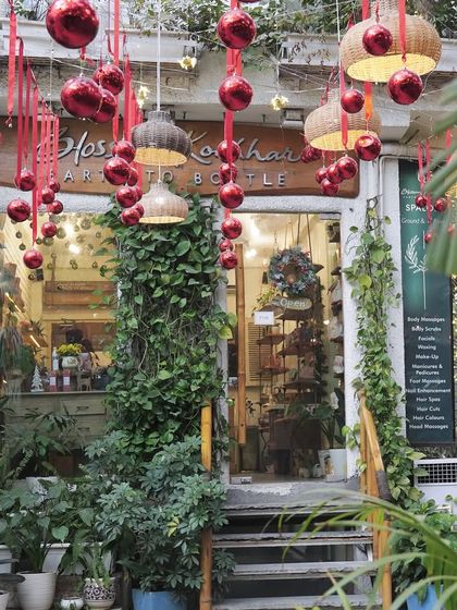 My salon entrance decorated for the Christmas season. The lush greenery and festive red ornaments create a warm and welcoming holiday vibe.