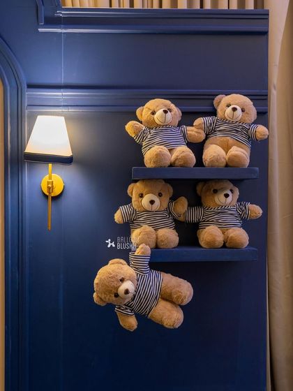 Even the walls are part of the story, with adorable teddy bears in striped shirts sitting on custom shelves next to elegant wall sconces.