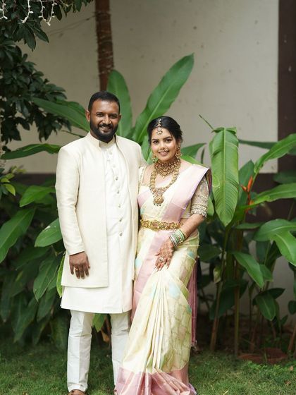 A couple posing with their baby, all in matching cream outfits. This is a perfect example of our family twinning service for creating beautiful, lasting memories.