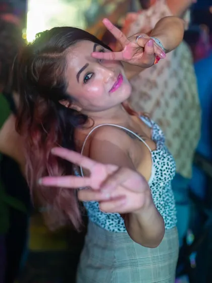 A guest making a peace sign, capturing the fun and friendly vibe.