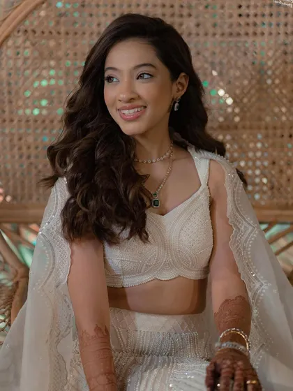 A portrait of the bride at her sangeet, her open hairstyle looking effortlessly glamorous.