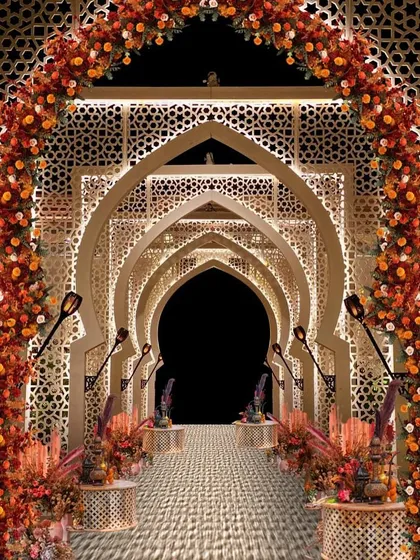 I love to transport guests to another world through immersive themes. This Turkish-inspired passageway uses intricate latticework arches, warm lighting, and rich floral arrangements to create the feeling of walking through a grand bazaar, making the journey to the main event an experience in itself.