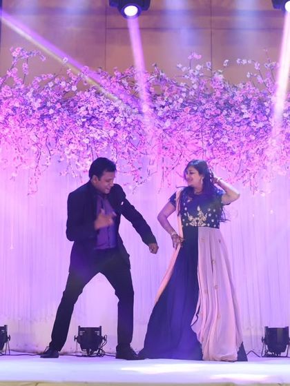 A sangeet is incomplete without a dance performance. This couple is perfectly in sync against a beautiful floral backdrop, showcasing a routine we designed for them.