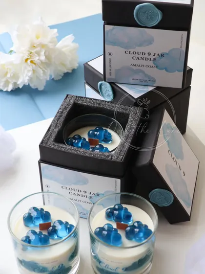 For the dreamers, I created the 'Cloud 9' jar candle. This limited edition piece features gel wax clouds floating in a soy wax sky, all beautifully presented in a custom-designed box with a wax seal.