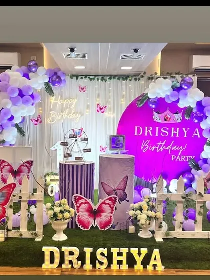 A purple butterfly theme with a circular backdrop and a cutout photo of the birthday girl.