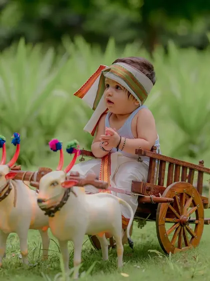 A moment of quiet contemplation for this little farmer. The details, from the turban to his tiny hands, are what make these cultural photoshoots so special and authentic.