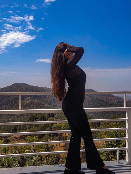 An all-black outfit against a stunning mountain backdrop. This look is simple but makes a strong statement. I can help you style monochromatic looks that are anything but boring.