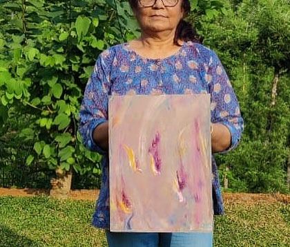 Holding one of my abstract paintings at the art camp in Wayanad. The serene environment was perfect for creating intuitive and expressive pieces.