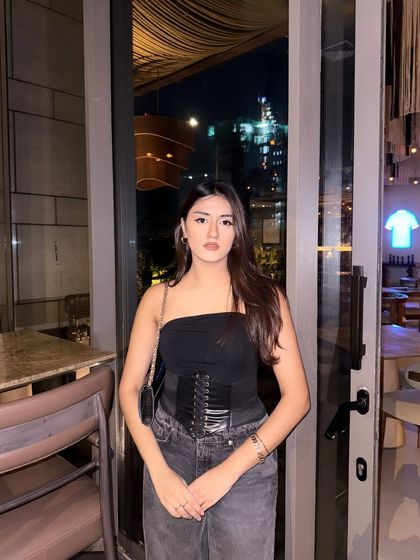 A confident, straight-on pose in the all-black outfit.