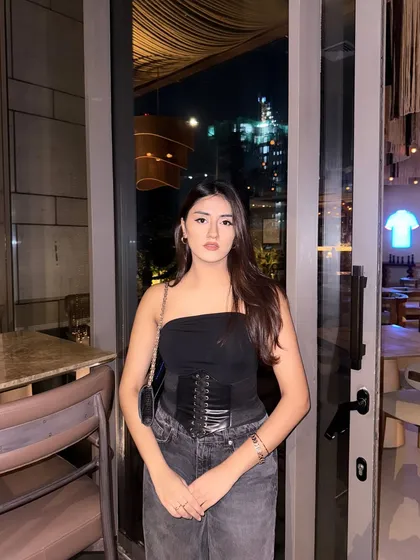 A confident, straight-on pose in the all-black outfit.