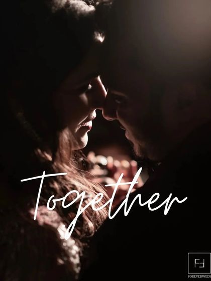 Together. A simple word for a profound feeling. This intimate, low-light portrait focuses on the closeness and connection between the couple, creating a deeply romantic and moody image.