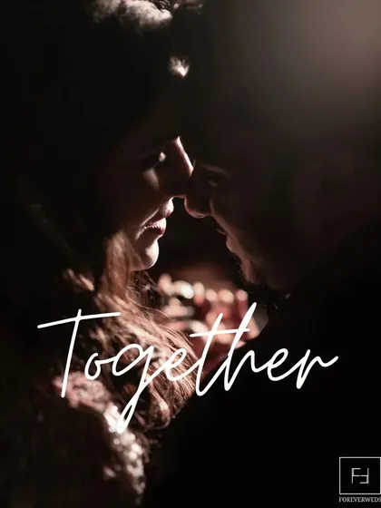 Together. A simple word for a profound feeling. This intimate, low-light portrait focuses on the closeness and connection between the couple, creating a deeply romantic and moody image.