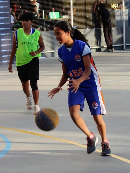 See the focus and determination. One of our talented young players drives to the basket during a competitive game. We are committed to developing female athletes, providing them with a platform to build confidence and showcase their skills.