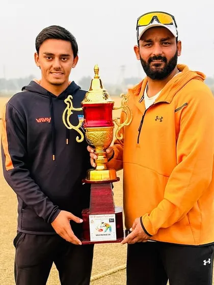 Holding the championship trophy with one of my key players. Teamwork and dedication brought this home for us.