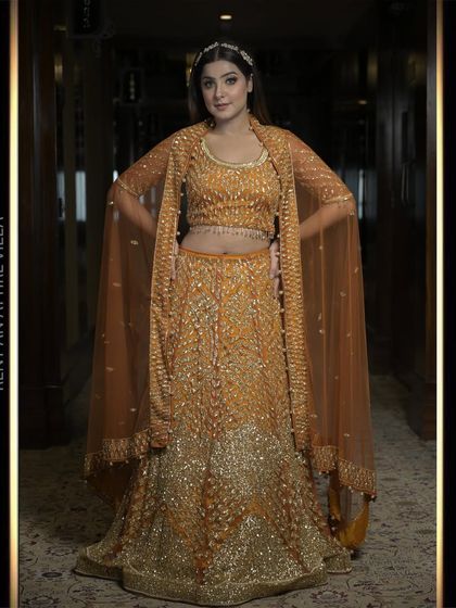 Another beautiful shot of the burnt orange lehenga, showcasing its flattering silhouette and the intricate details of the hand embroidery.