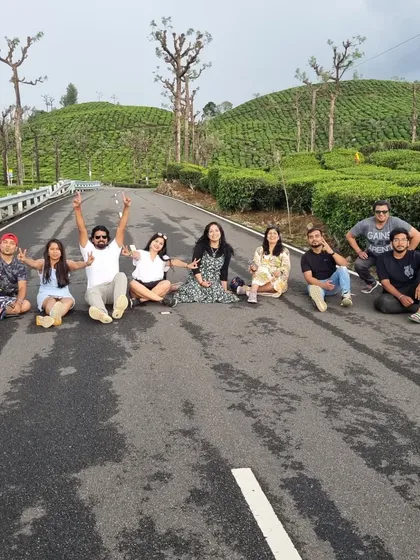 Sometimes the journey itself is the destination. We couldn't resist stopping for a group photo on this empty road winding through the lush tea plantations of Valparai.