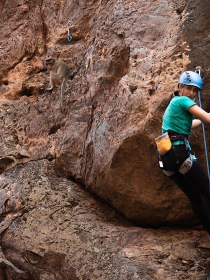 Sudha on a climb in Badami, with a monkey looking on. The wildlife is just one of the many things that make climbing outdoors so special.