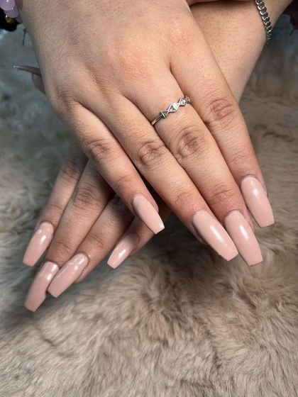 A soft, pink-toned nude on long coffin nails. This is a very flattering and popular choice.