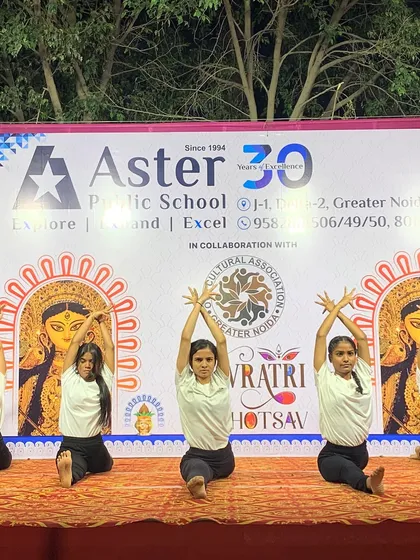 A synchronized seated pose with expressive hand gestures, part of our artistic routine for the Navratri Mahotsav.
